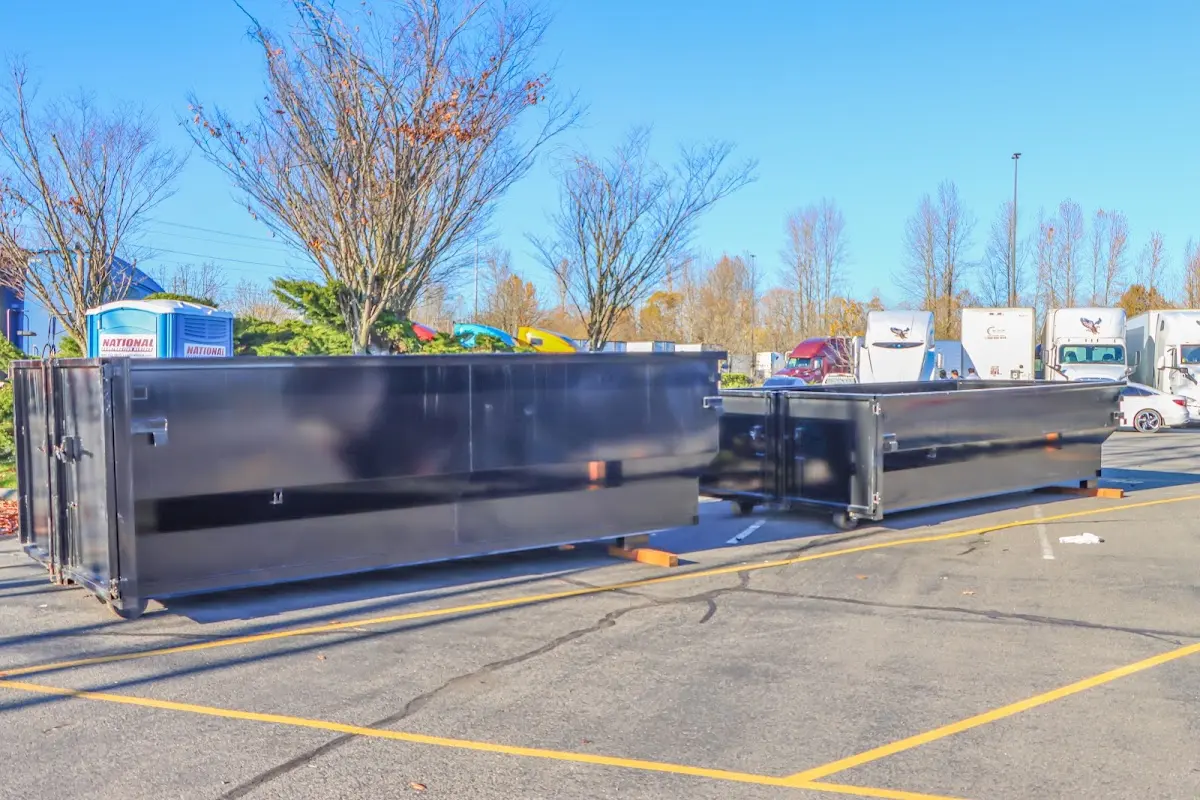 Professional dumpster rental service with roll-off container on residential driveway in Westminster